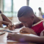 Boy writing on paper